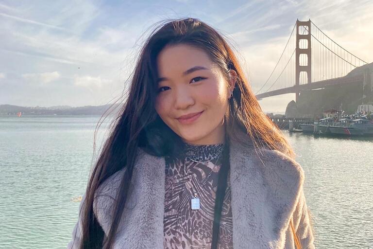 Connie Xu smiling in front of ocean