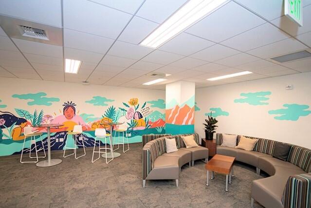 empty Basic Needs Center with colorful mural and sofas