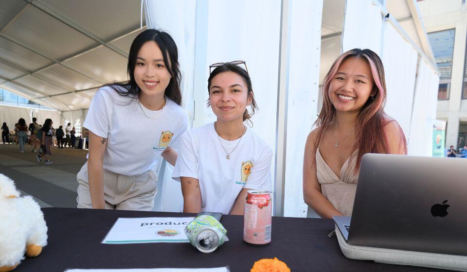 Three Students at Check-In Table