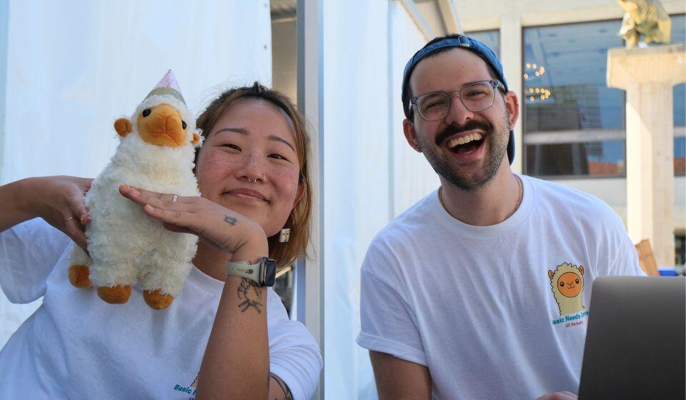 Staff Smiling with Guanaco Stuffed Animal